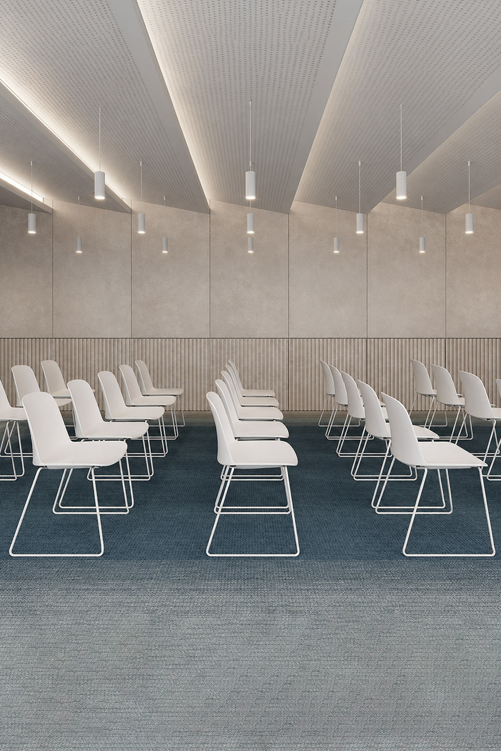 Les rangées de Siège visiteur Eos - piètement traineau de Monsieur Bureau sont disposées en deux parties, face à l'avant, dans une pièce minimaliste à la moquette bleue, aux murs beiges et aux luminaires suspendus, créant ainsi un espace élégant pour les réunions ou les présentations.