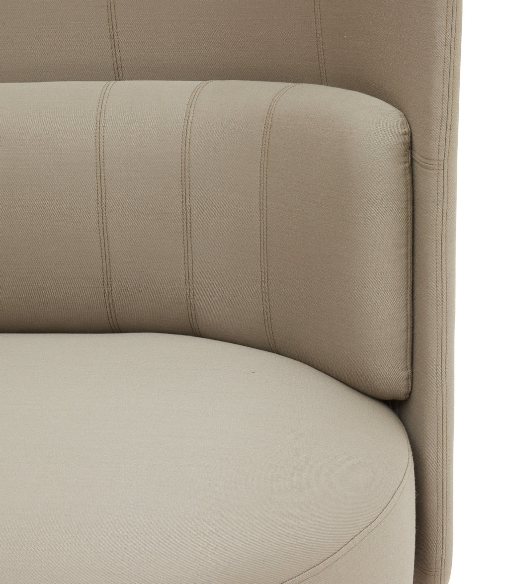 Gros plan sur le Canapé d'accueil dossier bas Jal de Monsieur Bureau, doté d'un revêtement beige moderne, d'un dossier incurvé avec surpiqûres verticales et d'un coussin d'assise lisse pour le confort, mettant en valeur le design épuré d'inspiration scandinave.